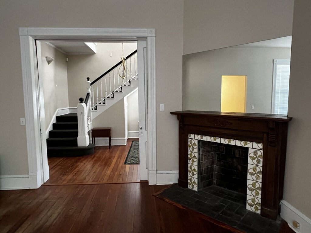 A parlor with a fireplace in the Artist Cottage