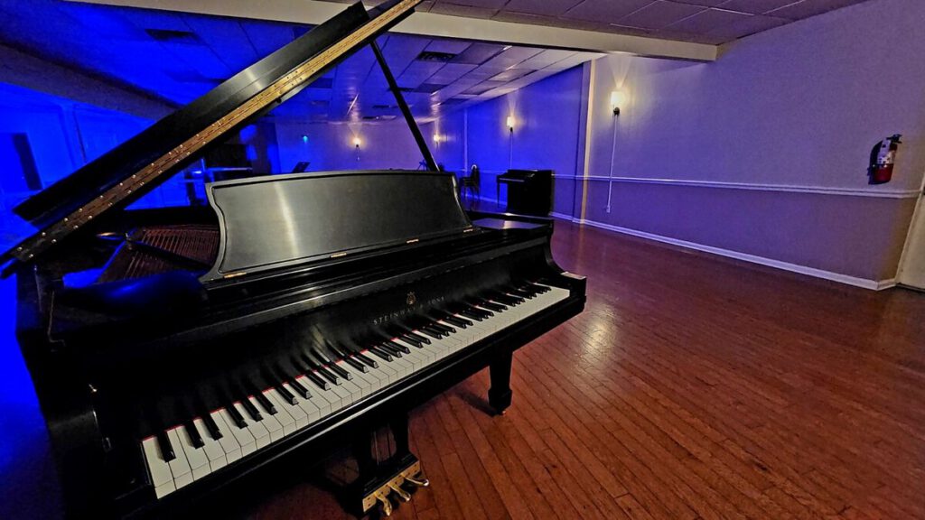 Grand piano lit in blue at The Blue Room at Friday Musicale